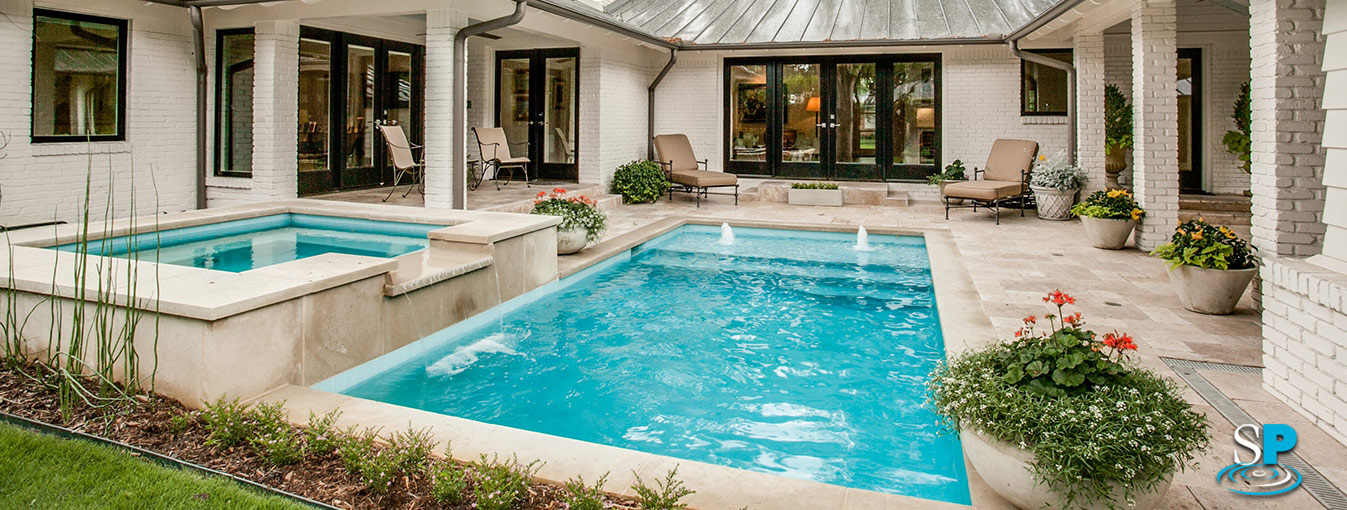 a rectangular pool with an attached spa